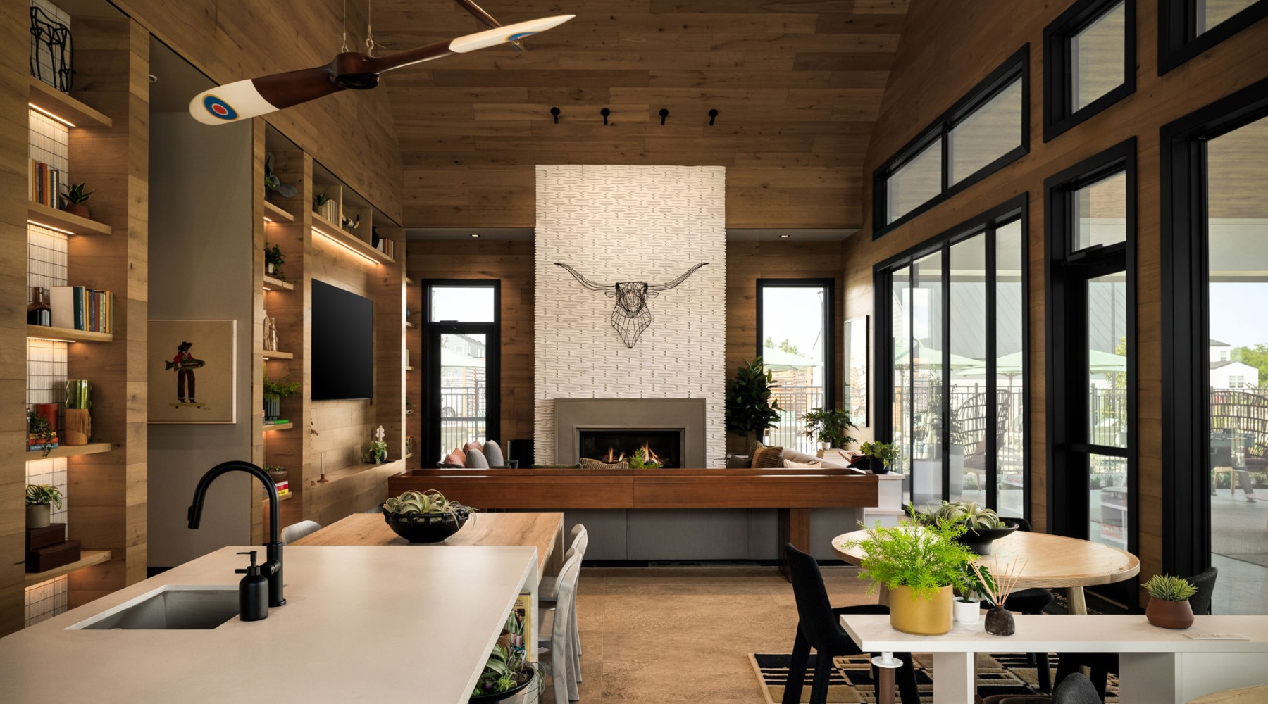 a resident amenity center with a large fireplace and kitchen