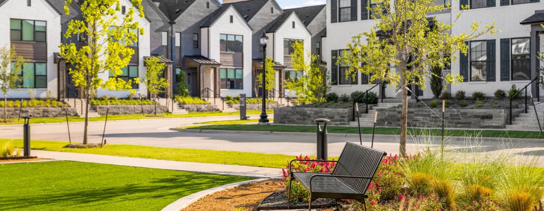 rows of rental townhomes and park bench
